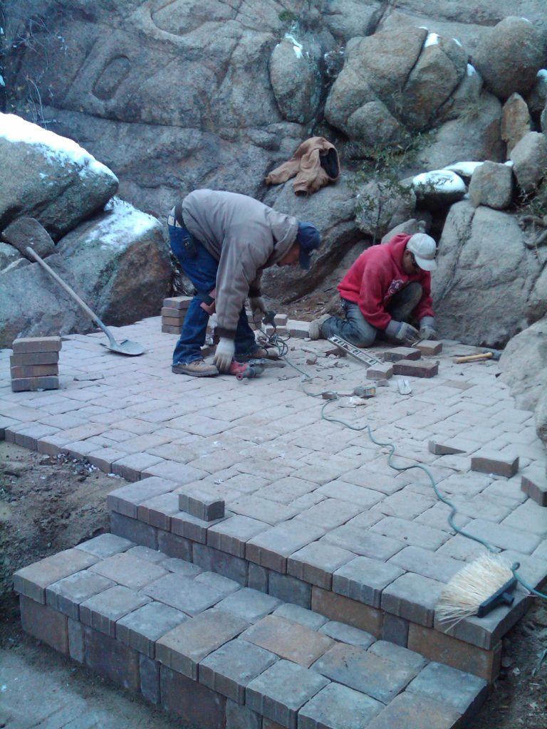 workers from vicente landscaping doing paver work