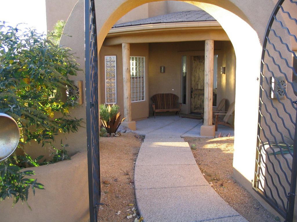 A entry way outside looking into a home with nice landscaping done