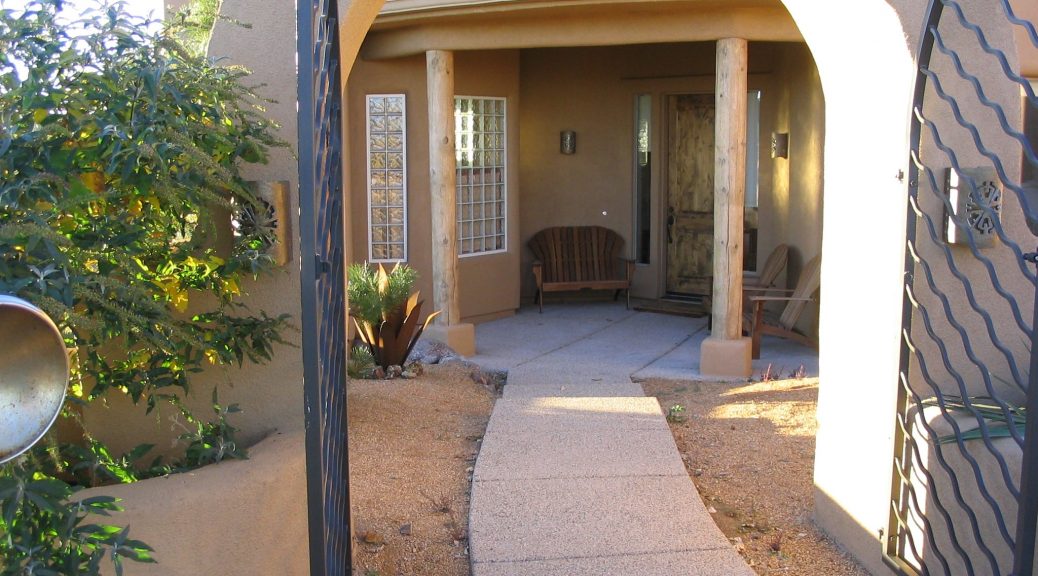 A entry way outside looking into a home with nice landscaping done